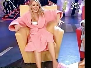 A sexy blonde woman shows off her feet in a TV show