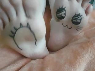 Kawaii japanese girl plays with her painted pale feet